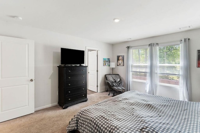 bedroom with light colored carpet, baseboards, and visible vents