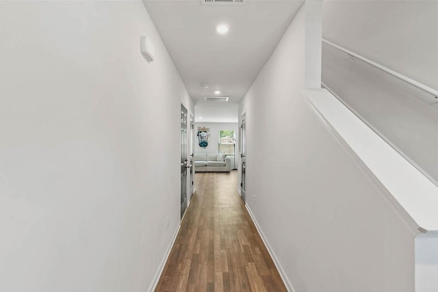 corridor featuring visible vents, wood finished floors, baseboards, and recessed lighting