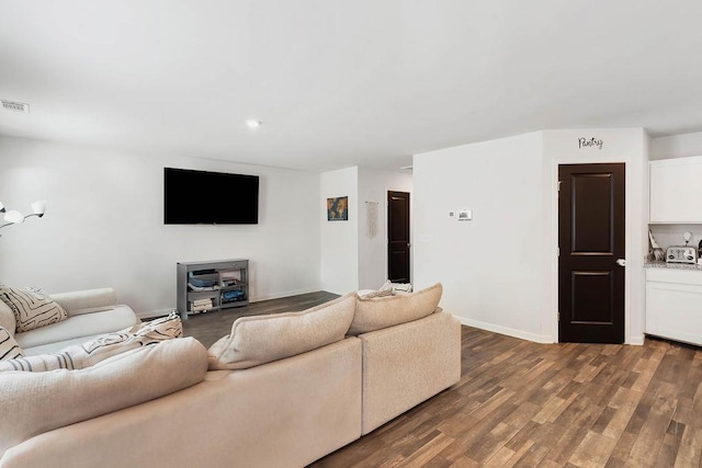 living area with recessed lighting, baseboards, visible vents, and wood finished floors