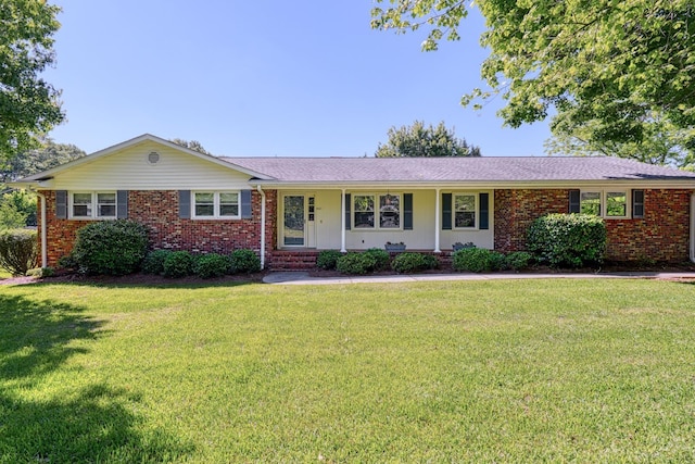ranch-style house with brick siding and a front lawn