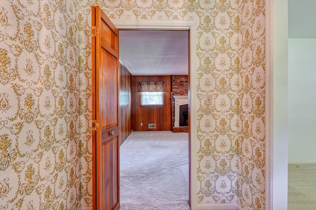 hallway with carpet flooring and visible vents