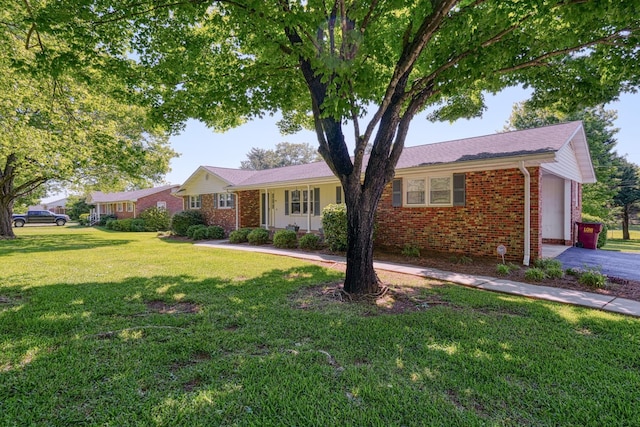 ranch-style house featuring brick siding and a front lawn