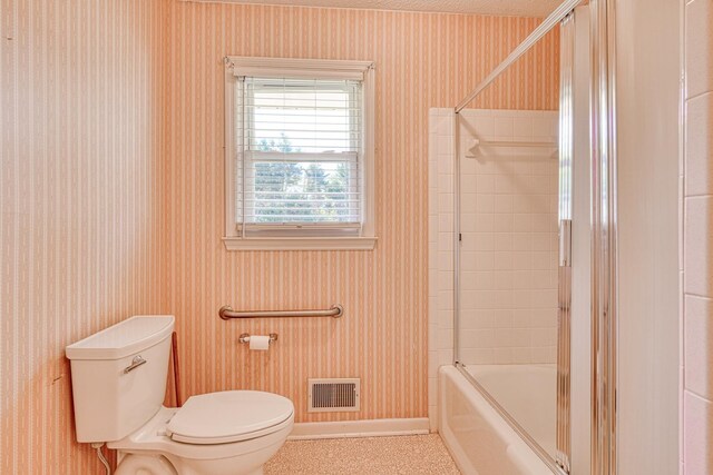 full bath featuring wallpapered walls, toilet, visible vents, and baseboards