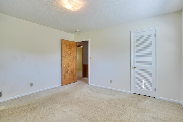 unfurnished bedroom with carpet floors and baseboards
