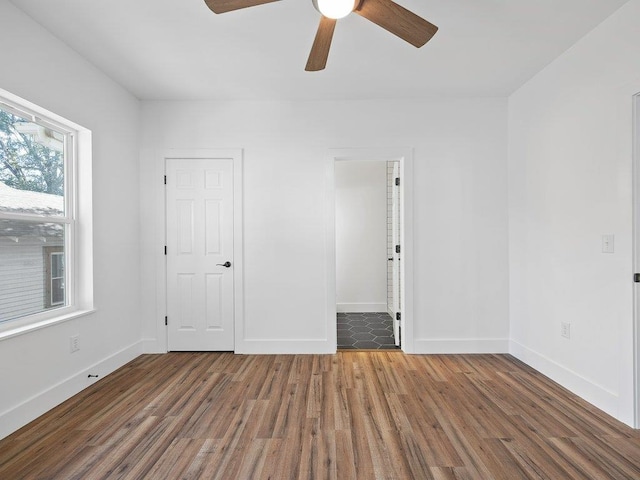 unfurnished room with ceiling fan, baseboards, and wood finished floors