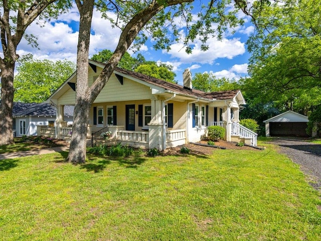 bungalow with covered porch, a front lawn, and a chimney