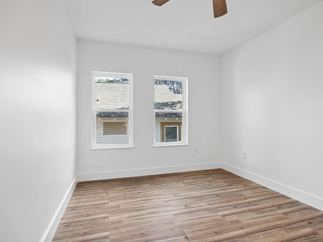 unfurnished room with light wood-style flooring, baseboards, and a ceiling fan