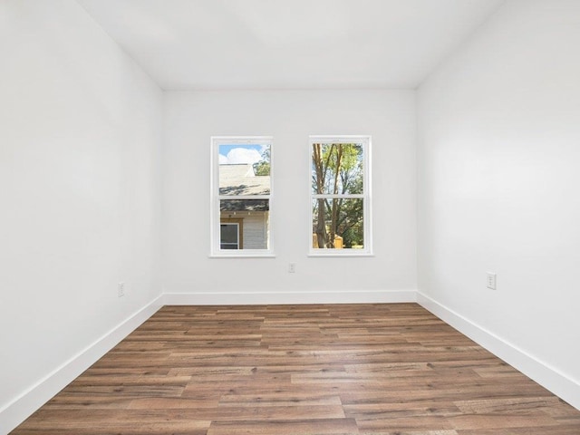 unfurnished room featuring wood finished floors and baseboards
