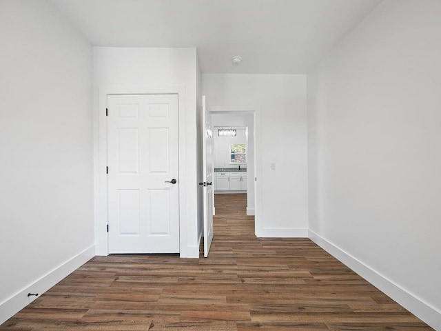 unfurnished bedroom with baseboards and wood finished floors