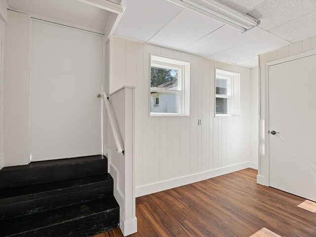 stairs featuring wood finished floors and baseboards