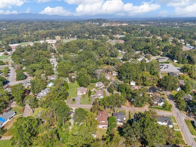 bird's eye view featuring a residential view and a wooded view