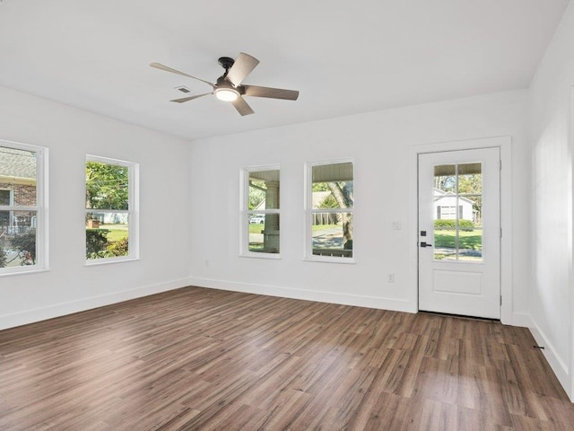 interior space featuring a ceiling fan, a healthy amount of sunlight, and wood finished floors