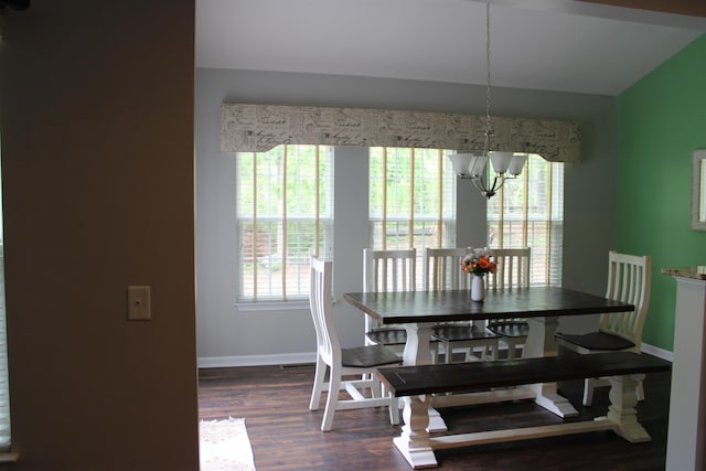 dining area with baseboards, a chandelier, and dark wood-style floors