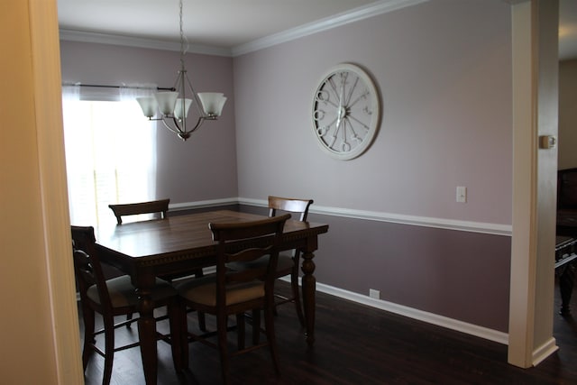 dining area featuring a chandelier, wood finished floors, baseboards, and ornamental molding