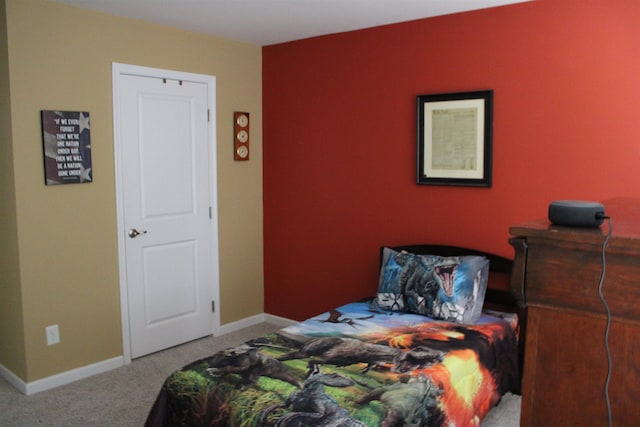 bedroom featuring carpet floors and baseboards