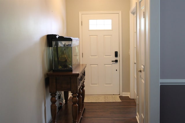 doorway with dark wood-style floors and baseboards