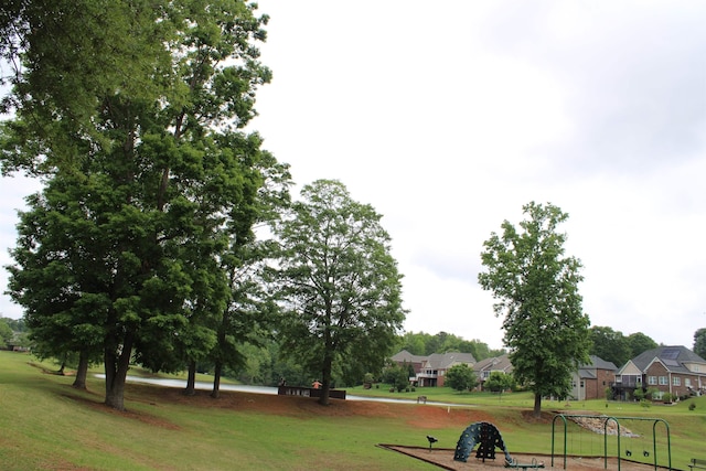 view of community featuring a lawn and a residential view