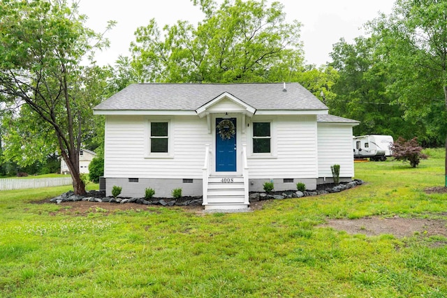 view of front of house with crawl space, roof with shingles, a front yard, and entry steps