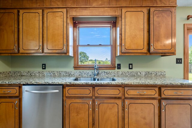 kitchen featuring a sink, stainless steel dishwasher, and brown cabinets