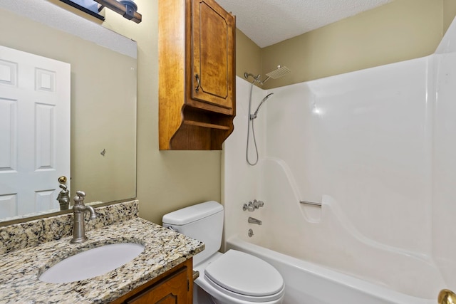 bathroom featuring a textured ceiling, vanity, toilet, and shower / bathtub combination