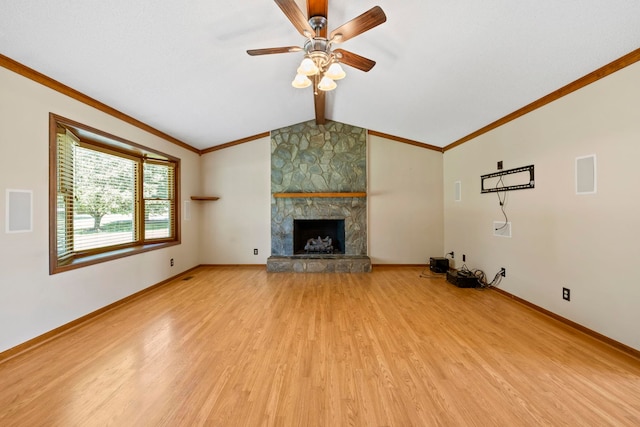 unfurnished living room with light wood-style flooring, ceiling fan, crown molding, a stone fireplace, and baseboards