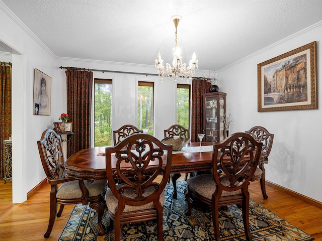 132 Rosecrest, Spartanburg, SC 29303 - dining room featuring a chandelier, light wood-style flooring, plenty of natural light, crown molding, and a textured ceiling