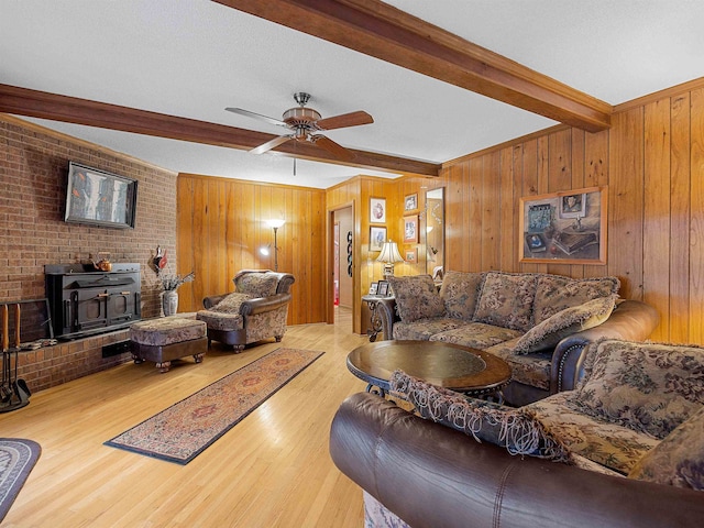 132 Rosecrest, Spartanburg, SC 29303 - living area featuring beam ceiling, a wood stove, wood finished floors, a ceiling fan, and wooden walls