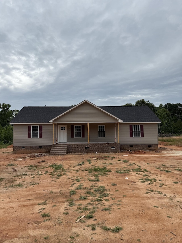 ranch-style house with crawl space, a shingled roof, and a porch