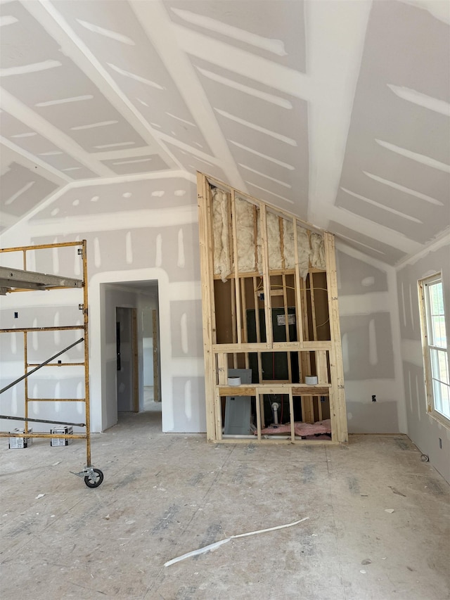 unfurnished living room featuring vaulted ceiling