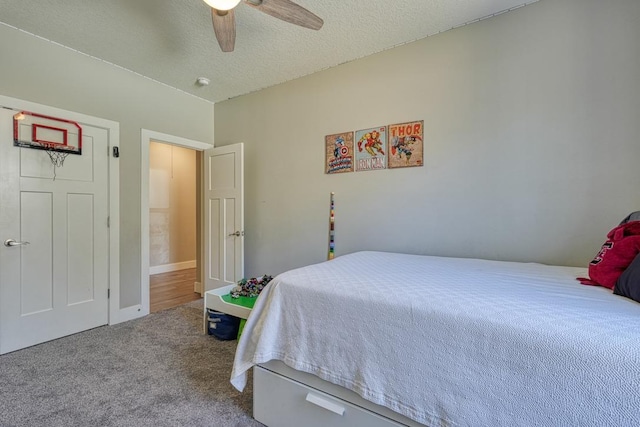 bedroom with carpet, a ceiling fan, and a textured ceiling