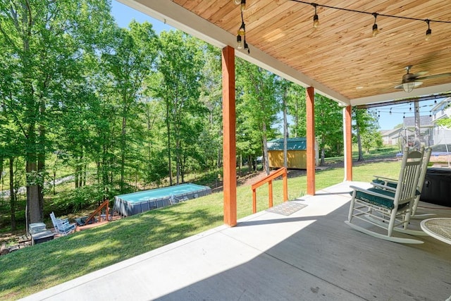 view of patio featuring a pool and a ceiling fan