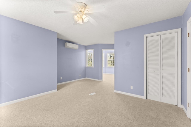 216 Ashmore, Greer, SC 29650 - unfurnished bedroom featuring a wall mounted AC, light colored carpet, a closet, a textured ceiling, and baseboards