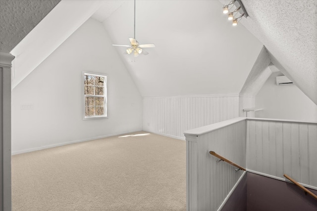 216 Ashmore, Greer, SC 29650 - additional living space with vaulted ceiling, carpet, a wall unit AC, a textured ceiling, and a ceiling fan