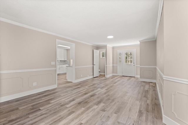 216 Ashmore, Greer, SC 29650 - empty room featuring crown molding, light wood-style floors, a decorative wall, a wainscoted wall, and recessed lighting