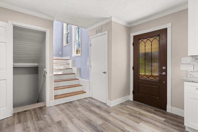 216 Ashmore, Greer, SC 29650 - entryway with stairs, light wood finished floors, crown molding, baseboards, and a textured ceiling