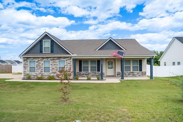 craftsman-style house featuring stone siding, roof with shingles, and a porch