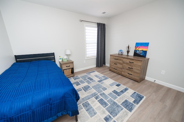 bedroom with wood finished floors and baseboards