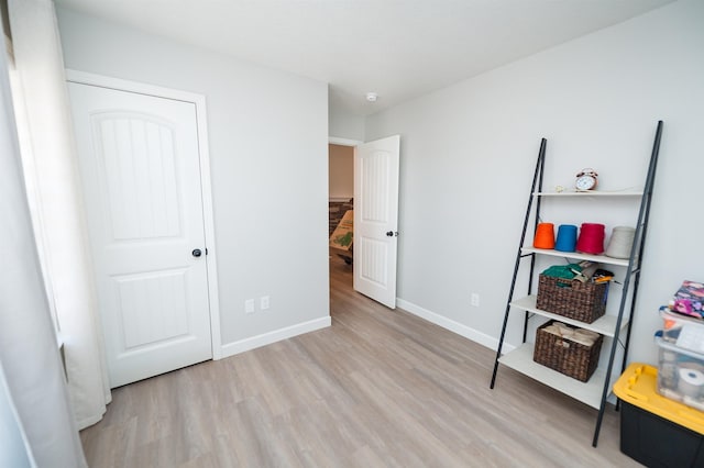 bedroom featuring light wood-type flooring and baseboards