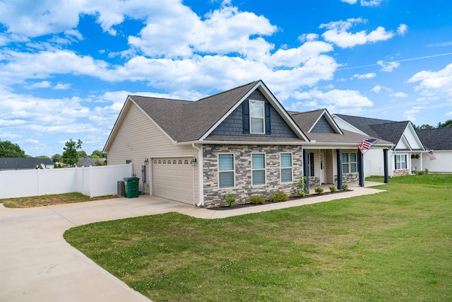 craftsman-style home featuring concrete driveway, stone siding, an attached garage, roof with shingles, and covered porch