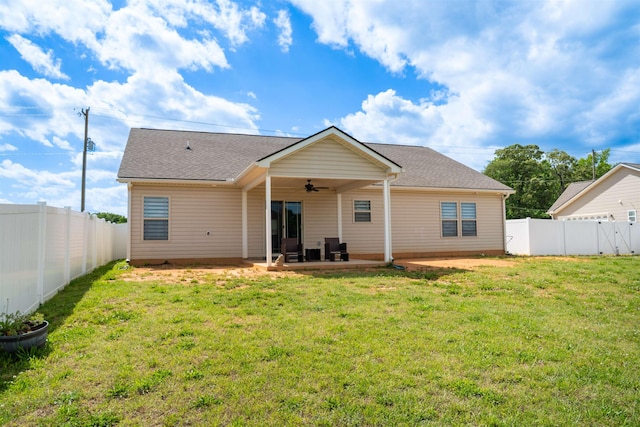 rear view of house featuring ceiling fan, a patio area, and roof with shingles