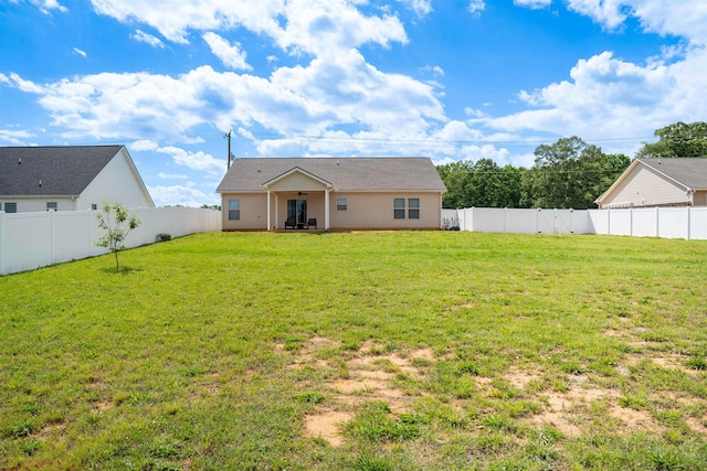rear view of house with ceiling fan and a patio