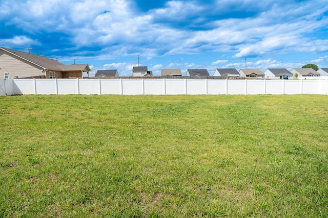 view of green lawn featuring a residential view