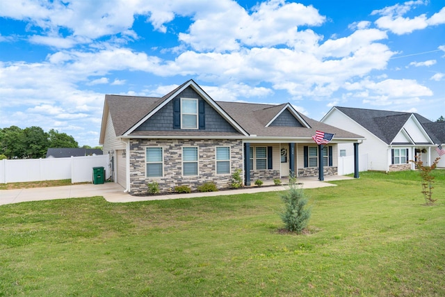 craftsman house with driveway, covered porch, stone siding, and a garage