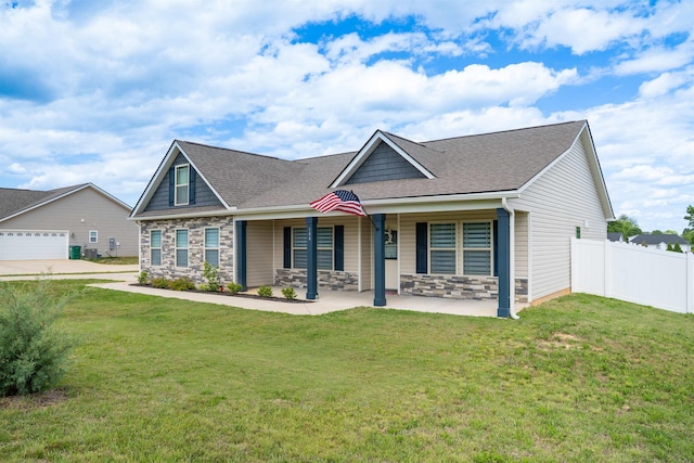 view of front of home featuring stone siding, a shingled roof, and a garage