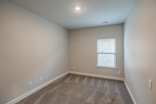 unfurnished room with carpet flooring and baseboards