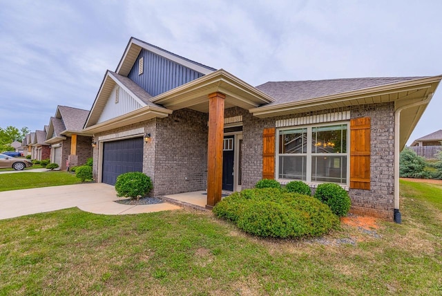 view of front facade featuring an attached garage, a front yard, concrete driveway, and roof with shingles