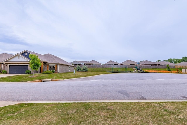 view of asphalt road with a residential view