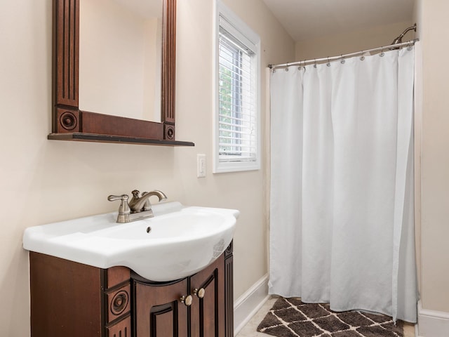 full bath featuring vanity, baseboards, and curtained shower