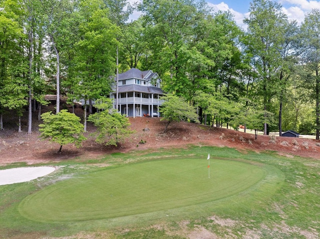 view of community with a putting green and golf course view