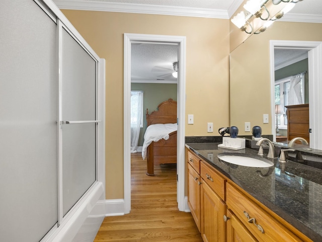 full bathroom with crown molding, an enclosed shower, wood finished floors, vanity, and ensuite bathroom